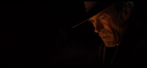 Clint Eastwood stares ruefully into a campfire in the movie Unforgiven Warner Bros Malpaso Productions